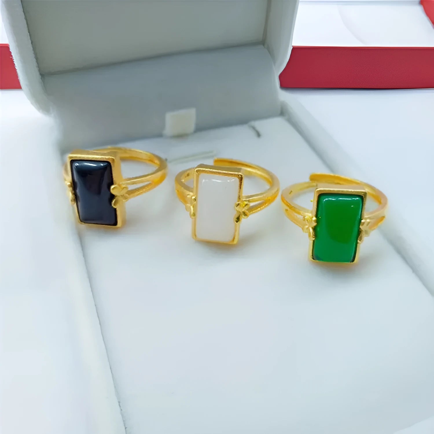 Adjustable brass gold-plated ring with a green gemstone inlay, showing national style design