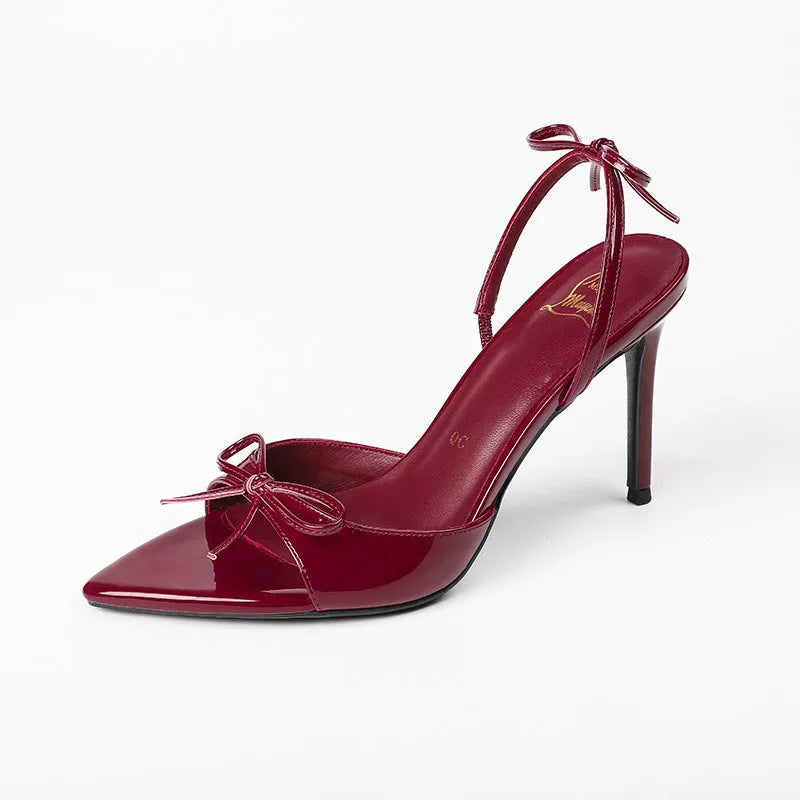 Women's black open toe stiletto high heels with pointed toe and ankle buckle.