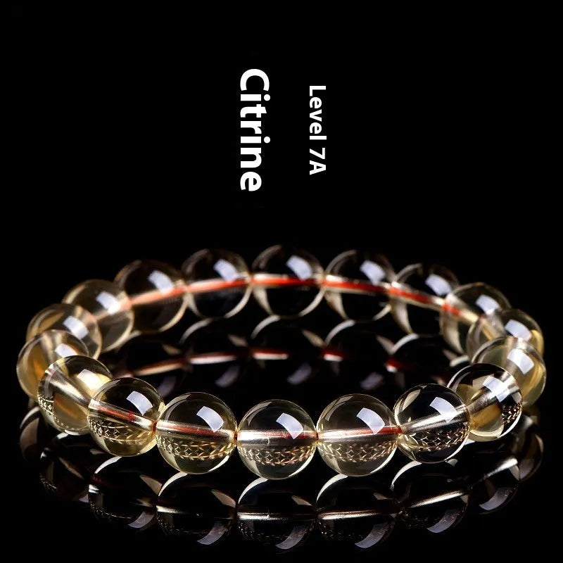 Adjustable natural citrine scattered beads bracelet on a wrist, showing polished yellow gemstones in an organic pattern.