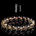 Adjustable natural citrine scattered beads bracelet on a wrist, showing polished yellow gemstones in an organic pattern.