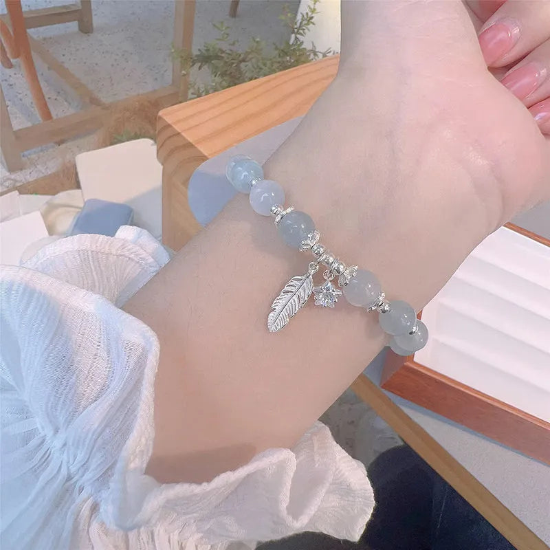 Small white crystal bracelet with blue moonlight colour and star design, Korean-style glass jewellery.