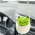 Green and white knitted wool car plant ornament hanging from a rope