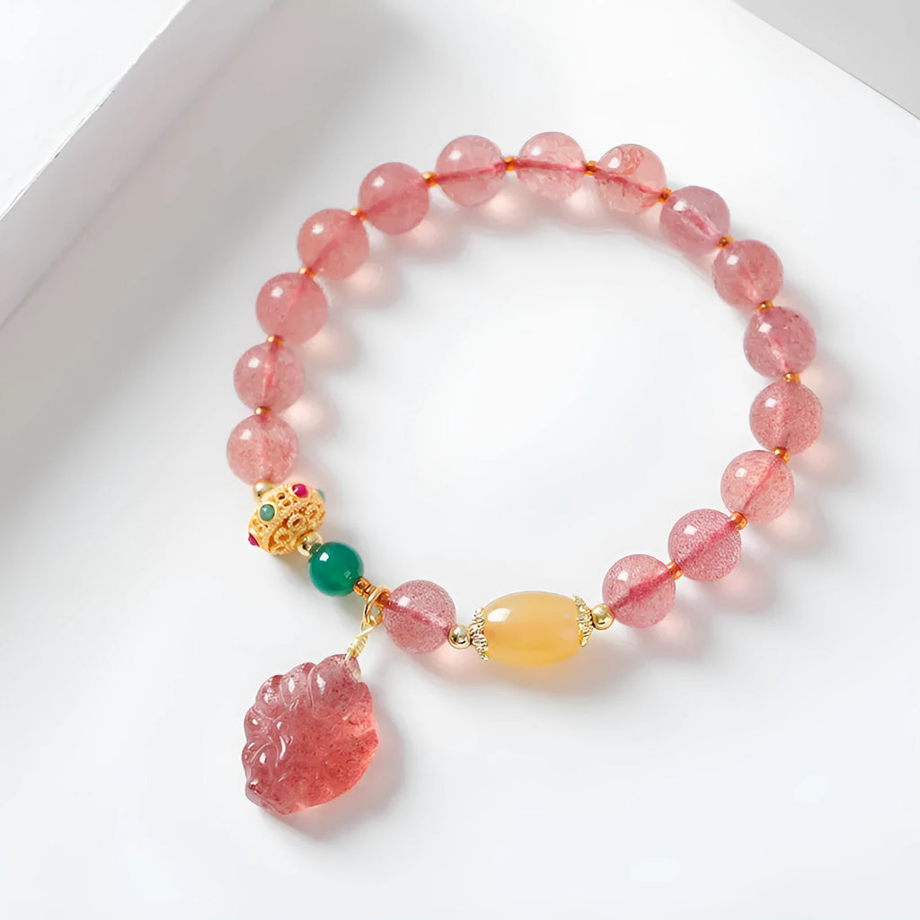 Women's polished crystal beaded bracelet with strawberry quartz and a nine-tail fox charm.