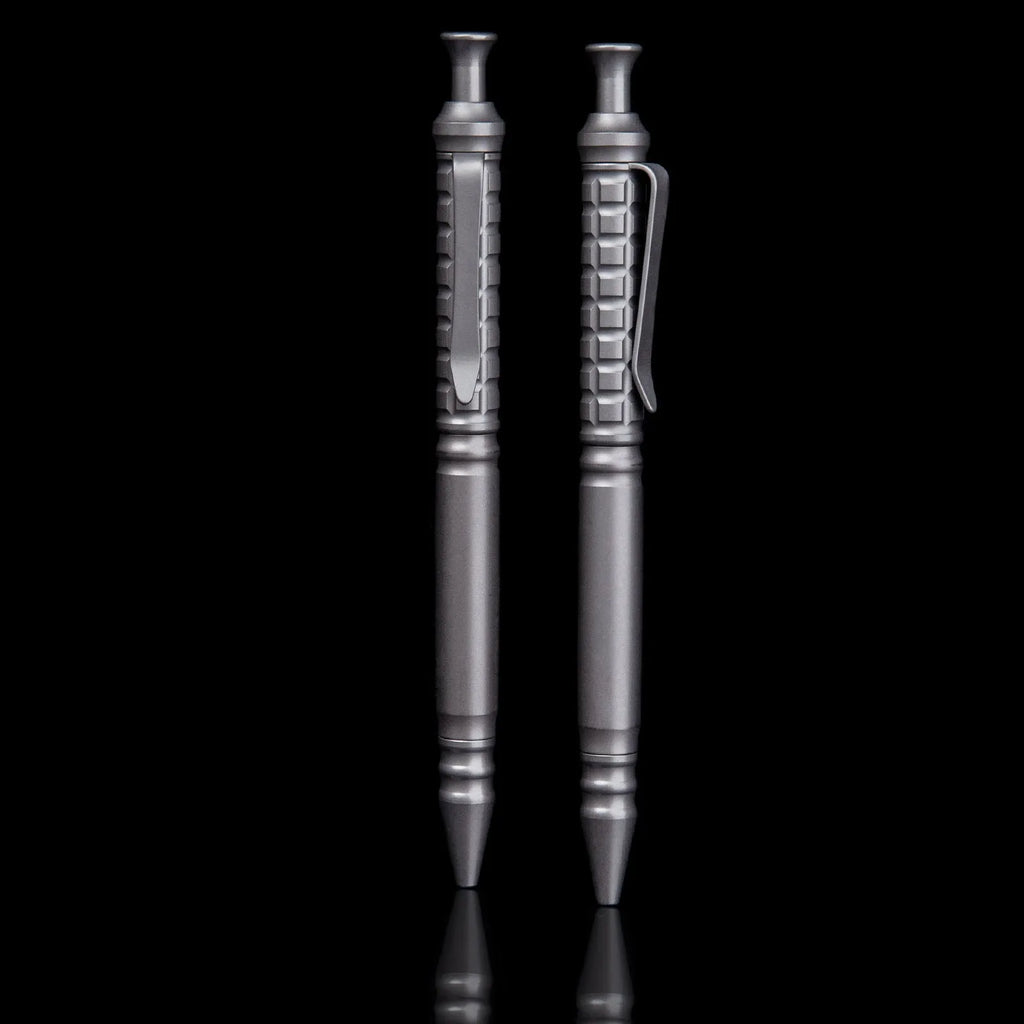 Gunmetal grey titanium alloy tactical pen with push-action mechanism and 0.5mm nib in a gift box.