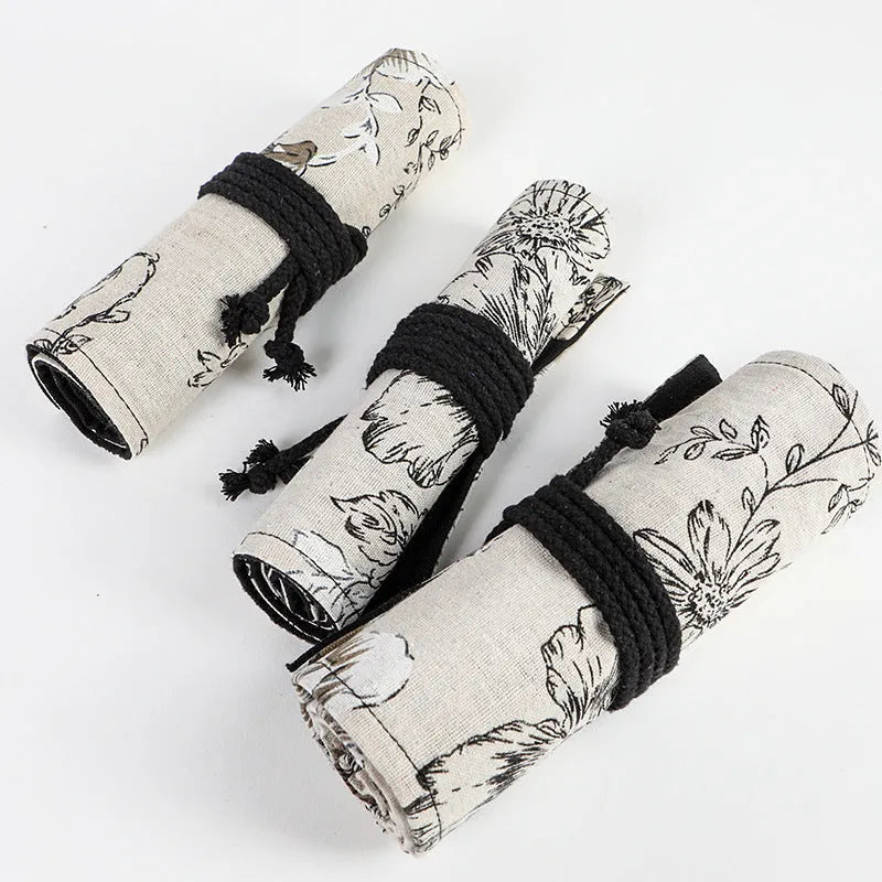 Black peony print canvas pencil roll bag showing cotton hemp construction with pencil storage holes