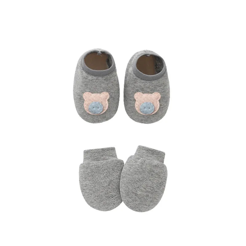 Set of white, light blue, and grey cotton baby pullover caps, gloves, and foot covers for infants.