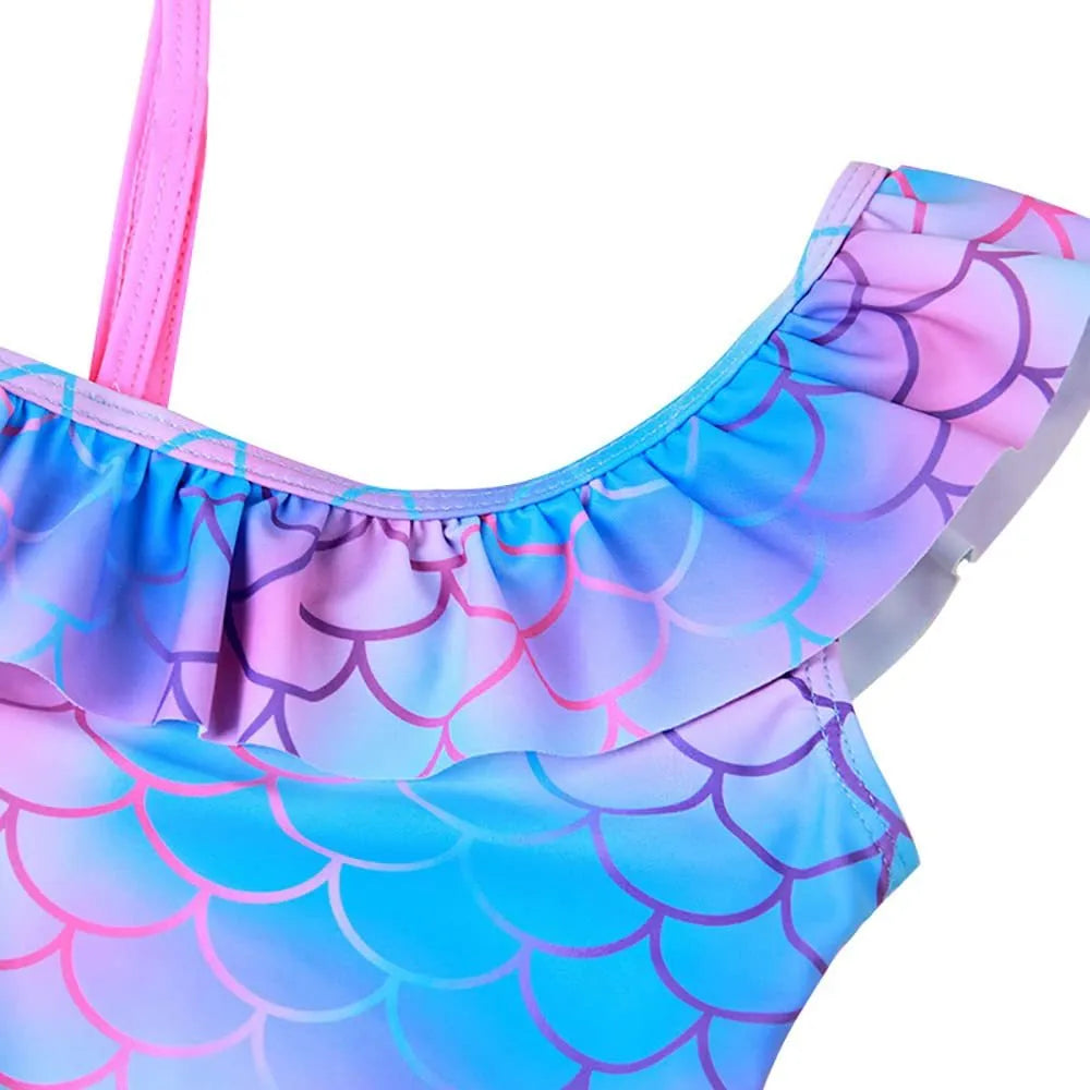 Girls' one-piece swimsuit with blue gradient fish scale print and flounced design.