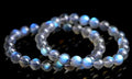 Natural blue moonlight crystal bracelet with cream body beads on a white background.