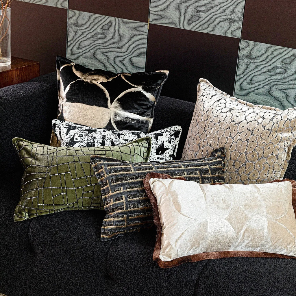 Black and gold abstract pattern flannel pillow cushion on a sofa, shown with removable cover.