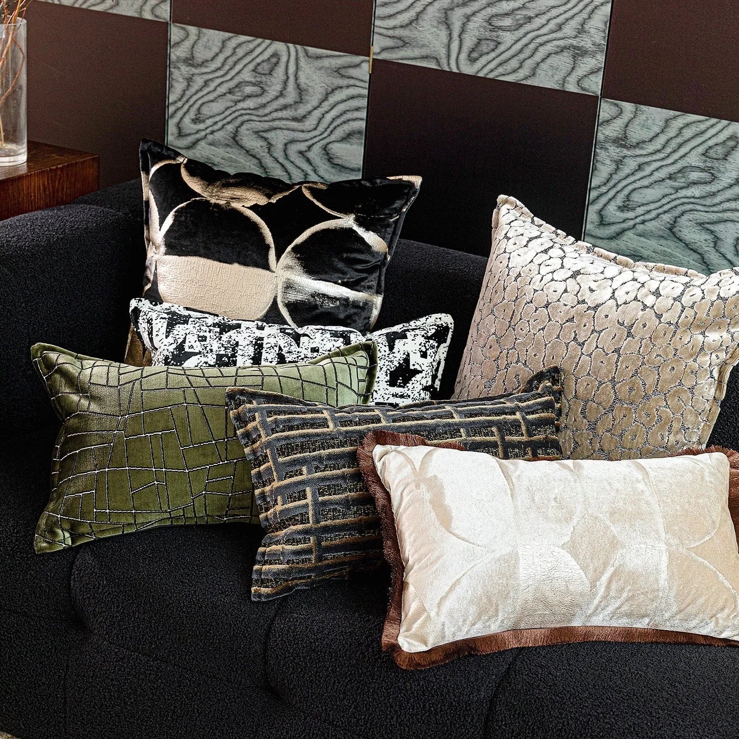 Black and gold abstract pattern flannel pillow cushion on a sofa, shown with removable cover.