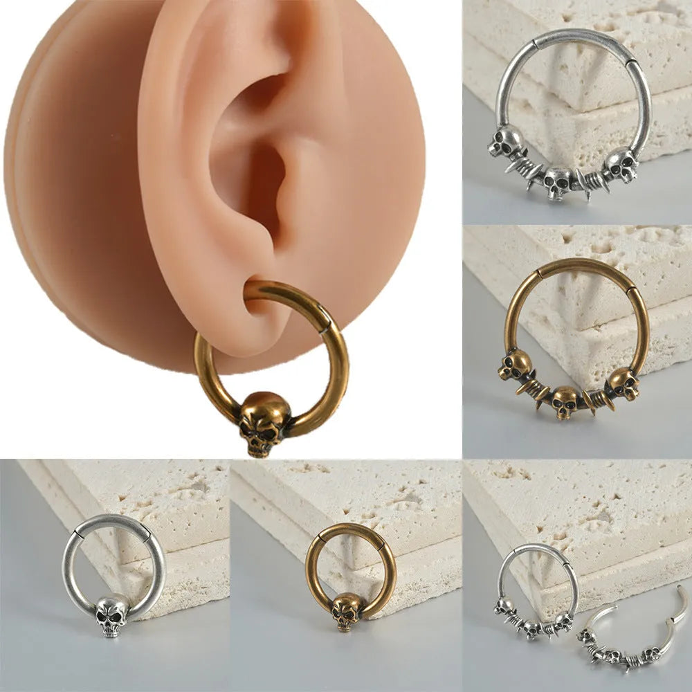 Close-up of handcrafted copper punk earrings with detailed vintage ghost head pendants on a 7cm drop wire.