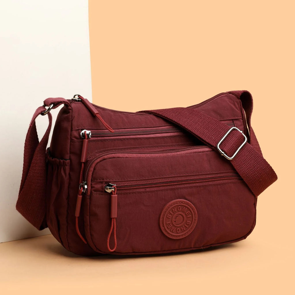 Water-repellent nylon crossbody bag with three-dimensional pocket shown in grey colour