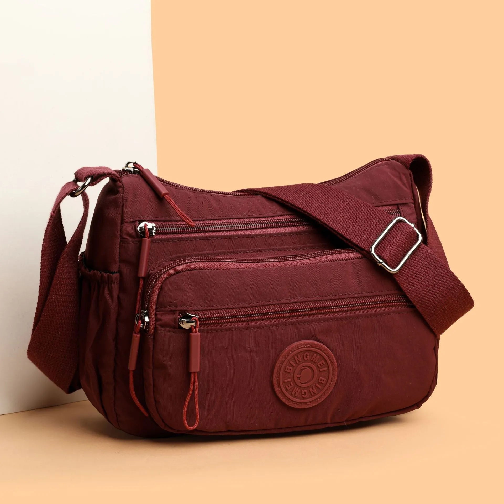 Water-repellent nylon crossbody bag with three-dimensional pocket shown in grey colour