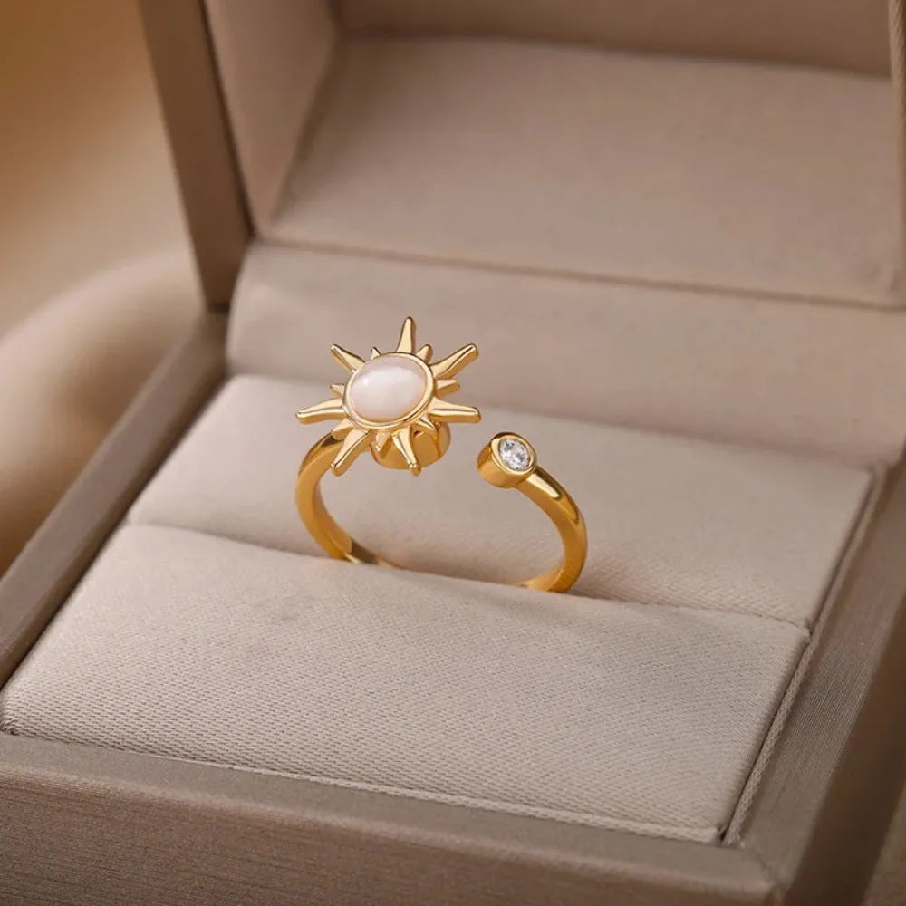 Adjustable rotating decompression ring in gold electroplated copper with geometric design