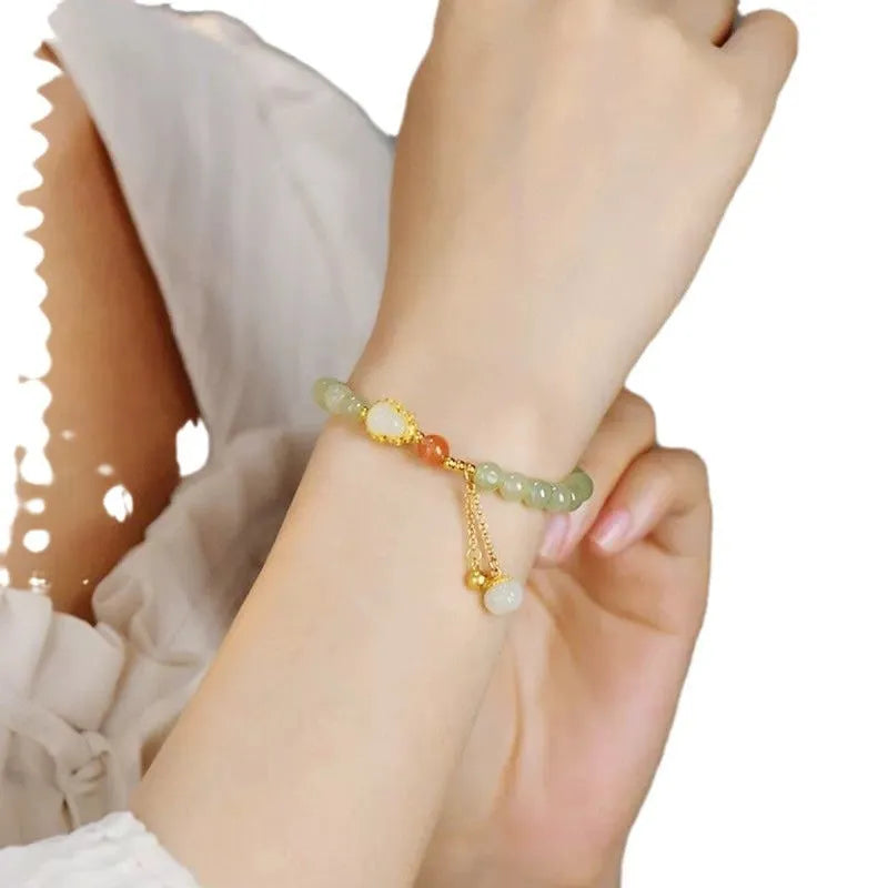 Qingshui jade bracelet with gold-plated details and a fu character on 6mm beads.