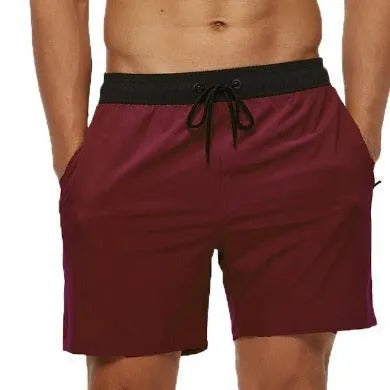 Men's blue stitching waist drawstring athletic shorts with a headband pocket and zipper fly.