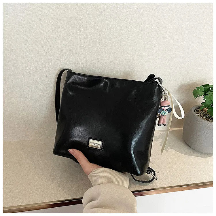 Women's casual crossbody bucket bag in black PU with sandwich pocket and silver hardware