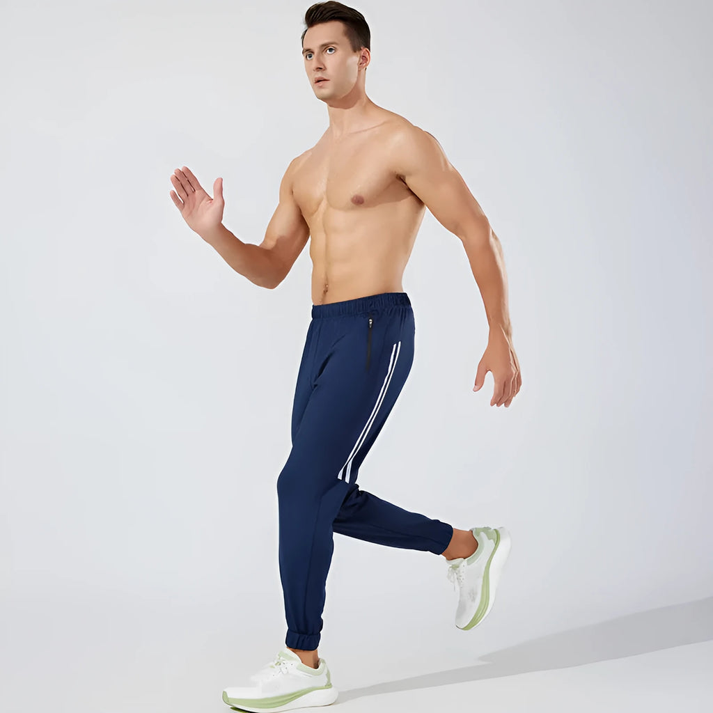Men's black polyester running trousers with a mid-waist, laid flat.