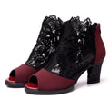 Women's black lace gladiator sandals with a square high heel and peep toe, showing zip closure