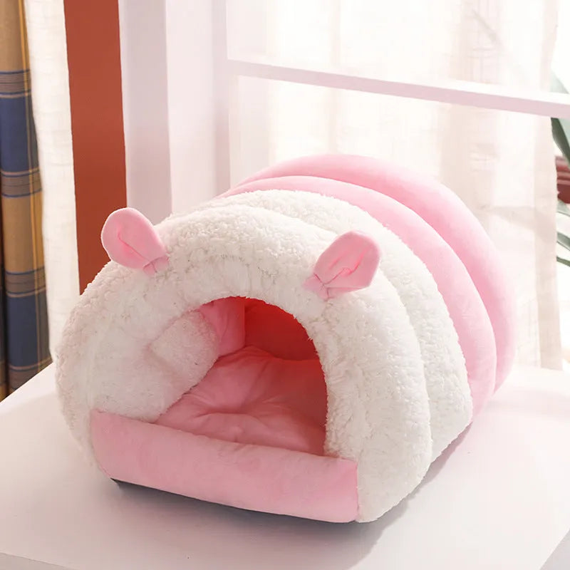 Closed cat nest bed in blue, shown with soft internal pad, illustrating its enclosed design for cats.