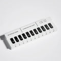 Black and white plastic piano-shaped parking sign with 'Piano Parking' text