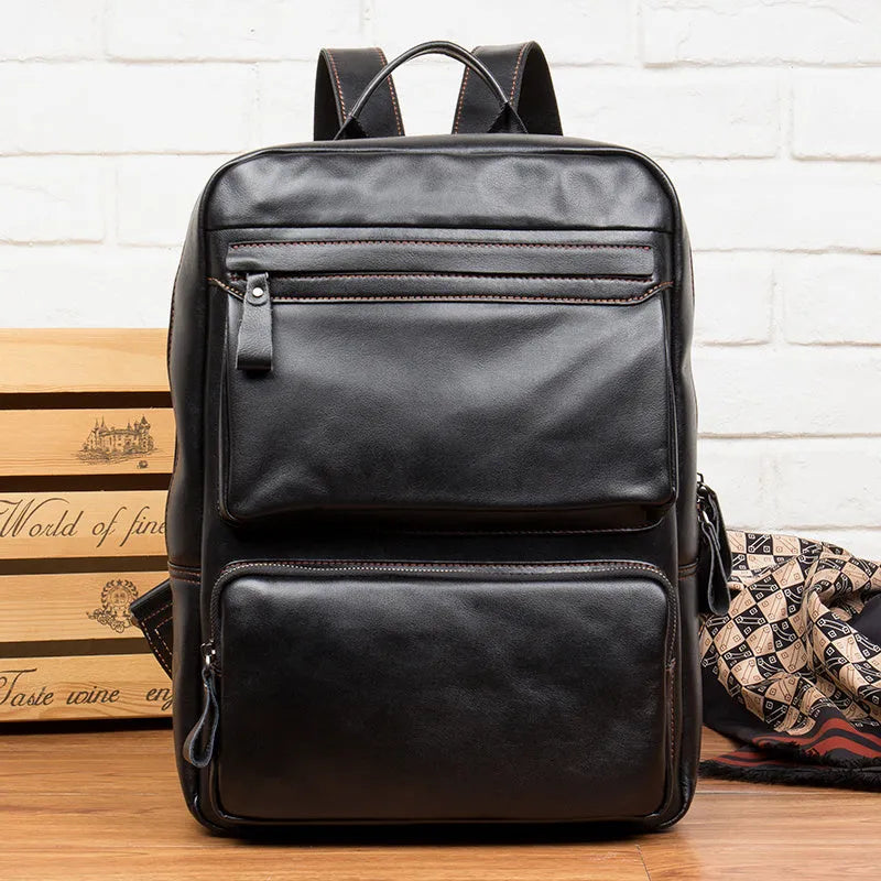 Large black cowhide leather backpack with vertical square shape and shoulder straps