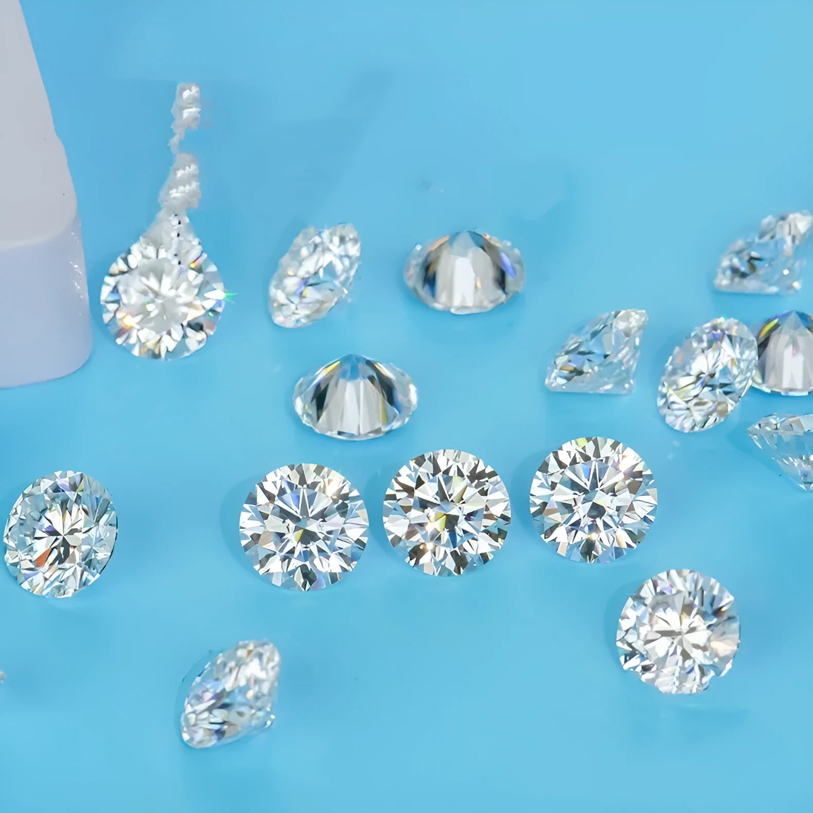 Round moissanite gemstone displaying the eight hearts and eight arrows faceting pattern on a neutral background.