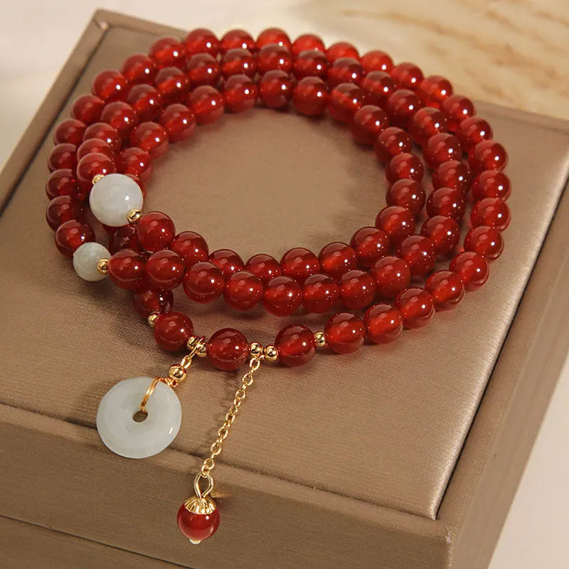 Red agate multi-layer crystal bracelet with a retro ethnic style on a white background.