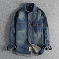 Men's light blue loose-fit vintage denim shirt with long sleeves on a hanger.