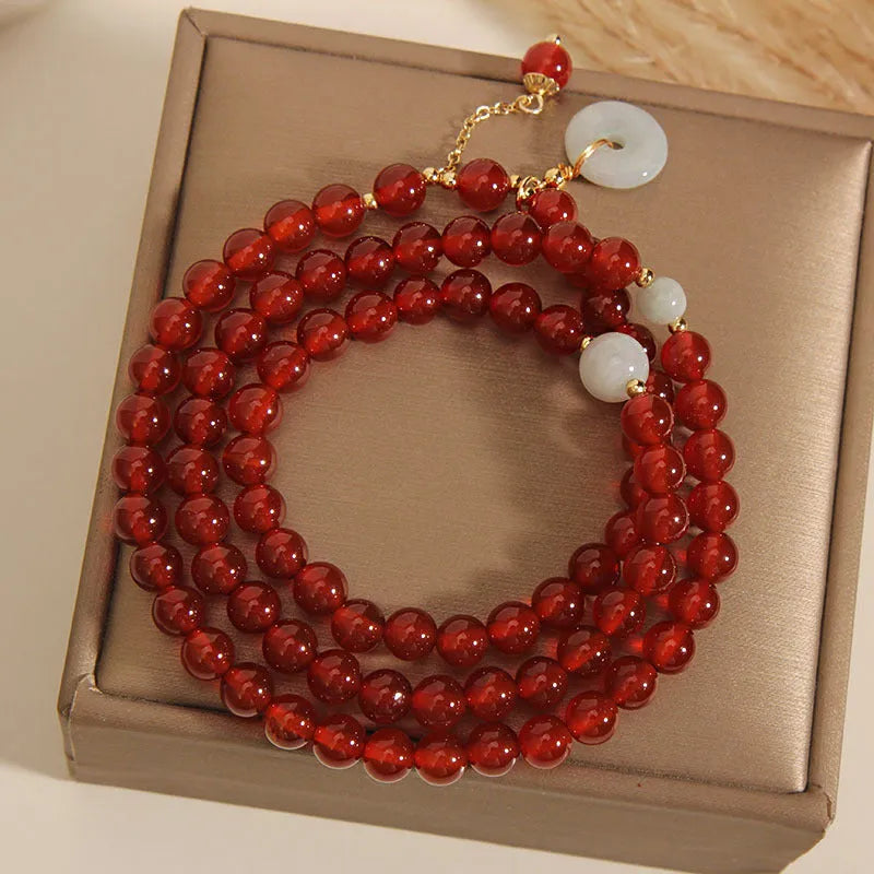 Red agate multi-layer crystal bracelet with a retro ethnic style on a white background.