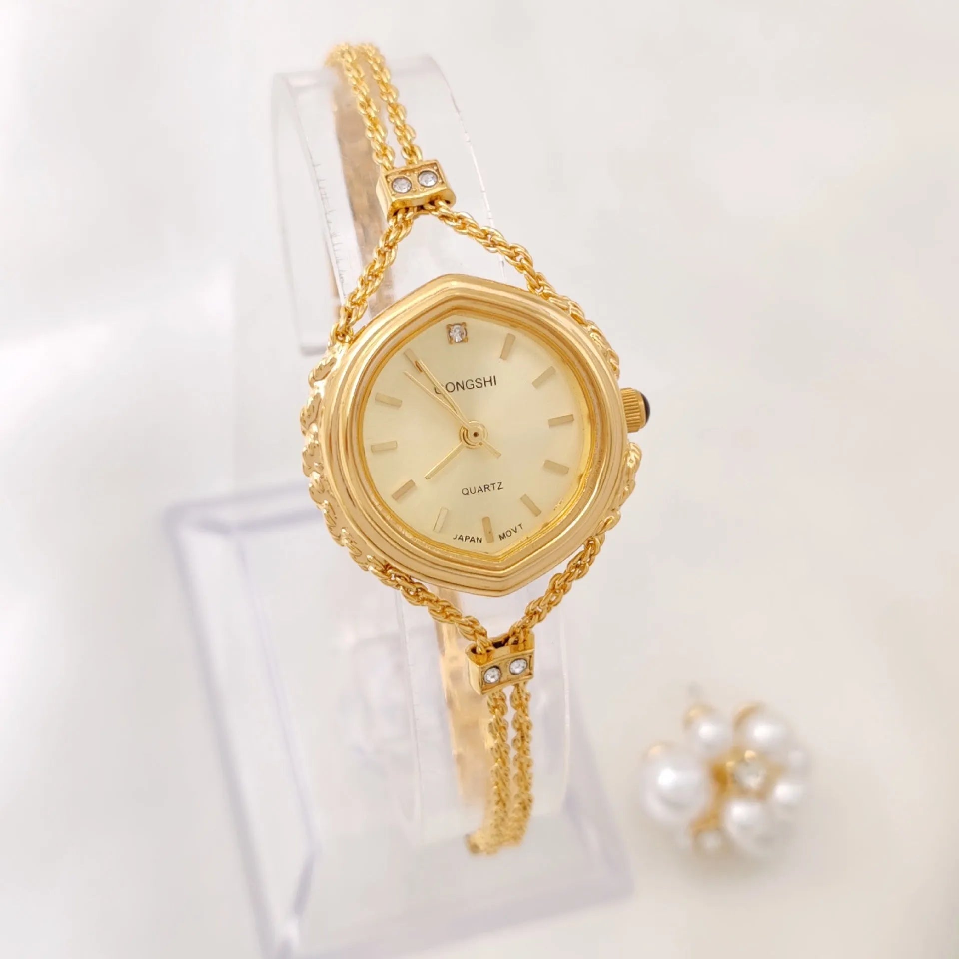 Gold and silver women's quartz watch with 25mm dial on a metal chain strap