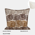 Cream and coffee abstract coil pattern square decorative pillow cover on a grey sofa.