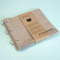Linen stitch fabric sketchbook in beige square format with ring binding and waist seal