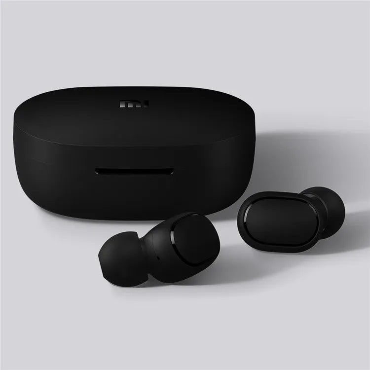 Black Redmi AirDots true wireless earbuds next to their compact charging case.