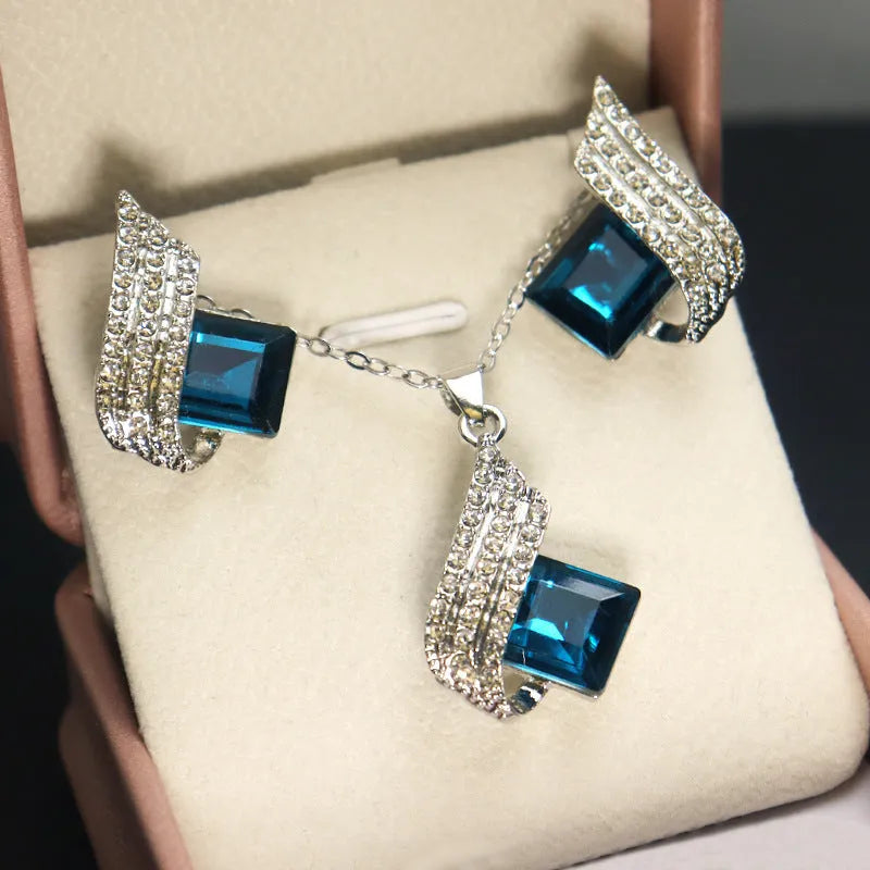 Silver-tone cross chain necklace and matching earring set with glass pendant details