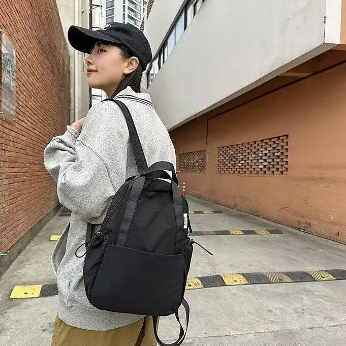 Simple solid colour ultra-light waterproof backpack with curved shoulder straps and lock