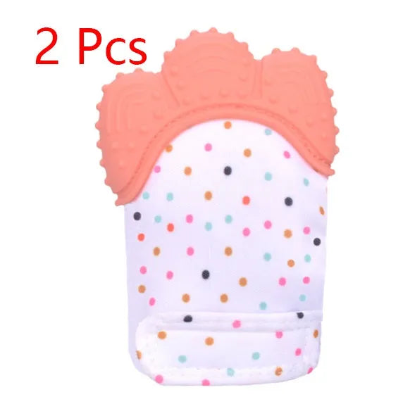 BPA-free silicone baby teether glove fastened with a white Velcro strap on a baby's hand