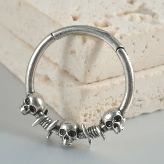 Copper punk earring with antique silver ghost head charm.