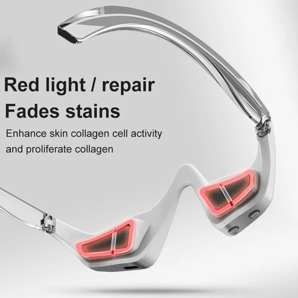 Pink and white micro-current eye massager with glasses-style design on a stand.