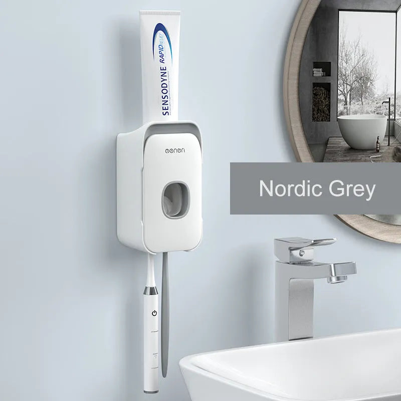 Blue, grey, and pink automatic toothpaste dispenser made of ABS plastic for wall mounting