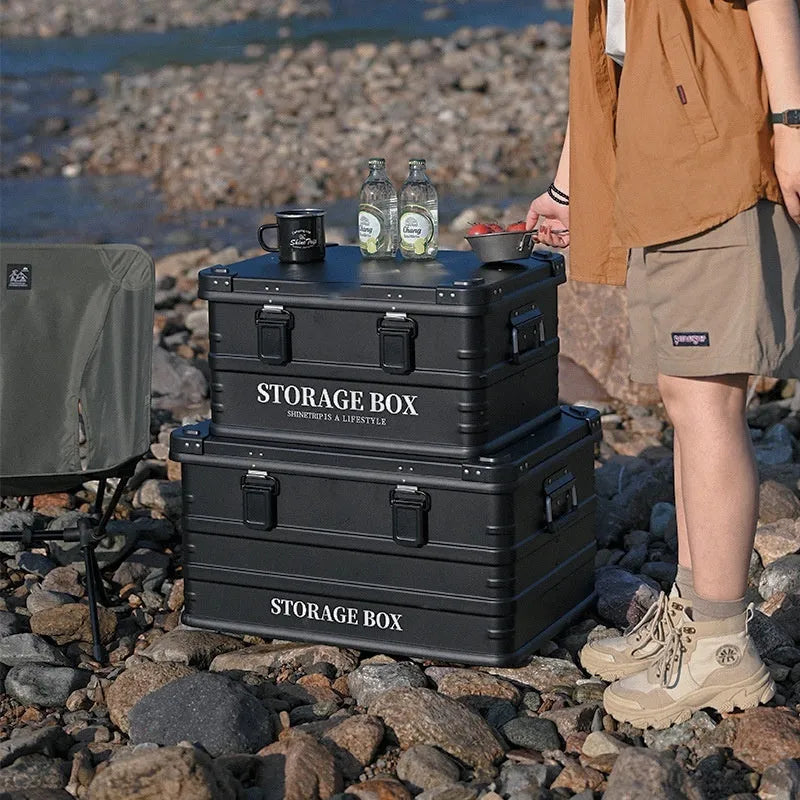 Army green waterproof plastic storage box sitting in a car boot