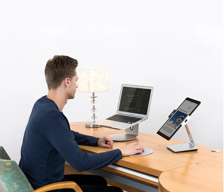 Foldable aluminium phone and tablet stand with black silicone protection showing 360-degree rotation capability