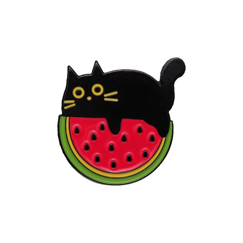 Colourful cartoon-style fruit metal brooch with pin clasp on a denim jacket lapel.
