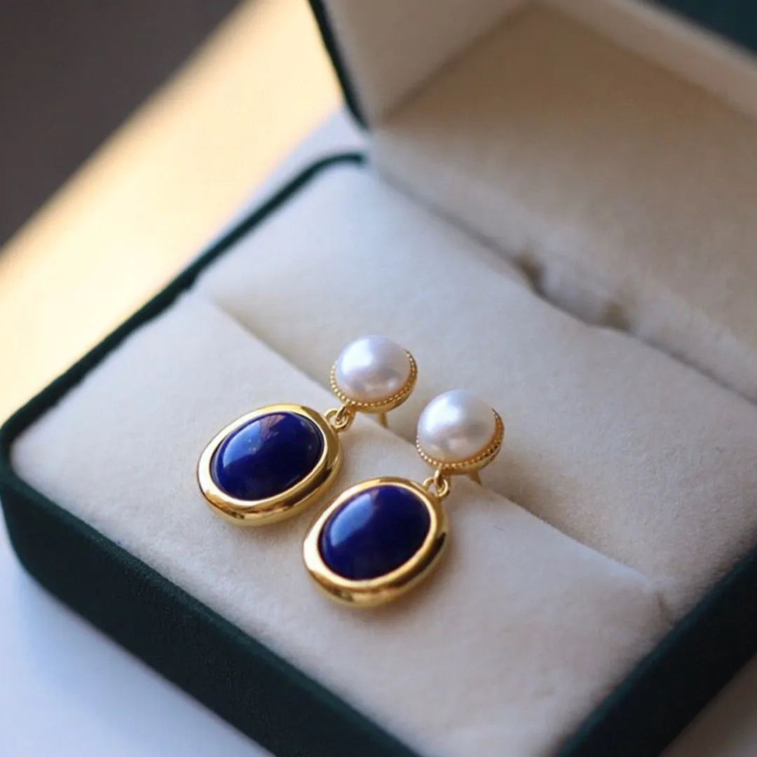 A pair of lapis lazuli pearl drop earrings on 925 silver posts with engraved patterns.