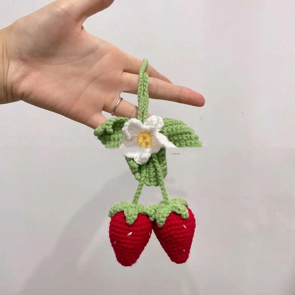 Handmade woven strawberry-shaped car pendant made from cotton and hemp yarn.
