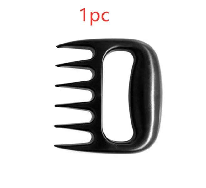 Two black bear claw meat shredders for barbecue preparation on kitchen counter