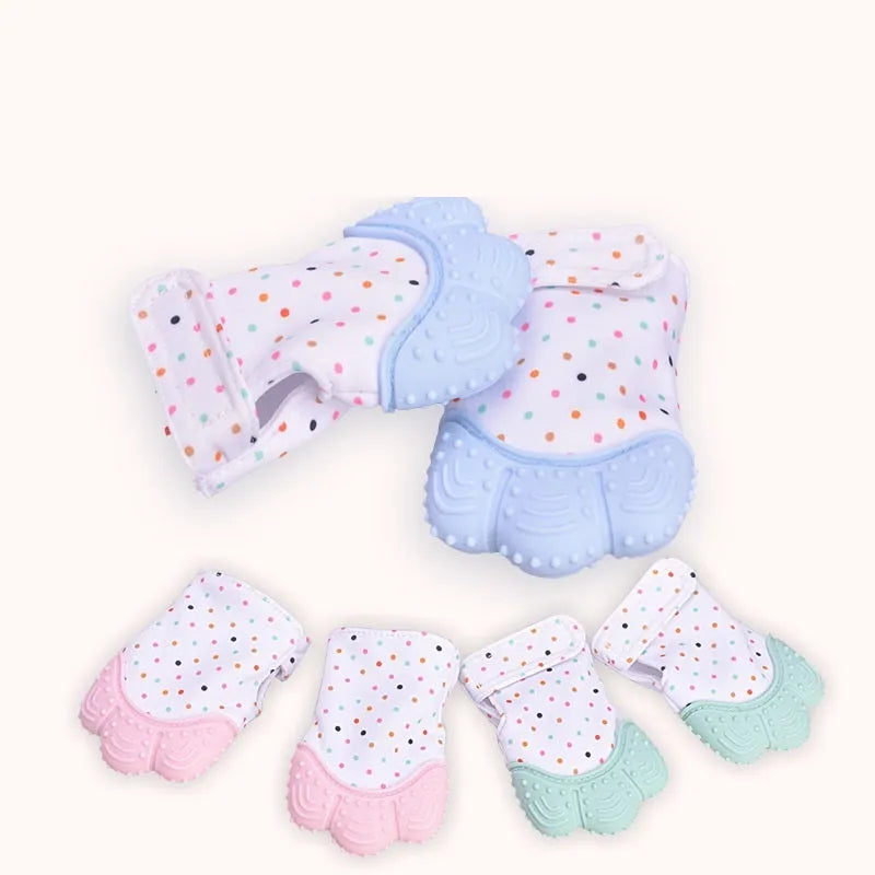 BPA-free silicone baby teether glove fastened with a white Velcro strap on a baby's hand