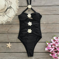 A women's solid colour one-piece swimsuit with a detachable skirt and hollow-out tube top.