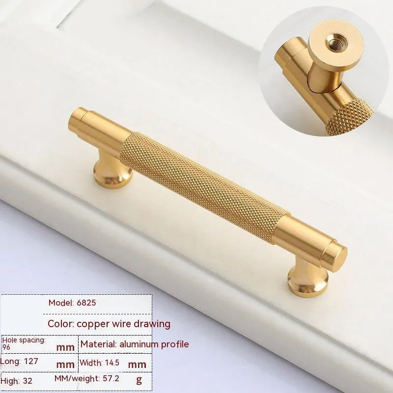 Brushed brass aluminium wardrobe handle with visible mounting holes for cabinet furniture.