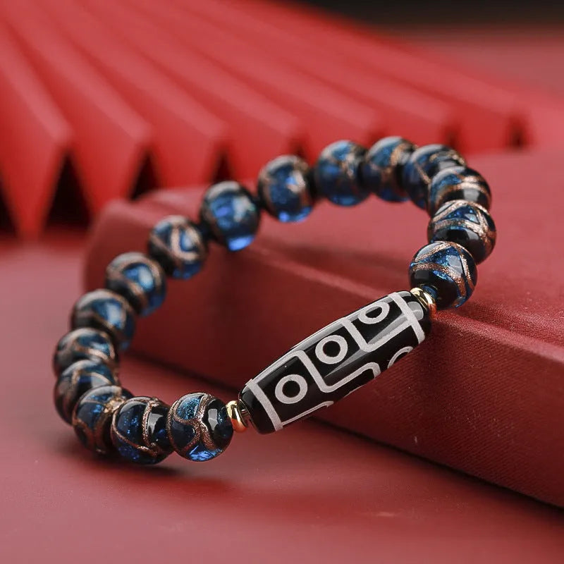 Close-up of a handmade Chinese-style bracelet with coloured glaze lucky beads on a snake theme.